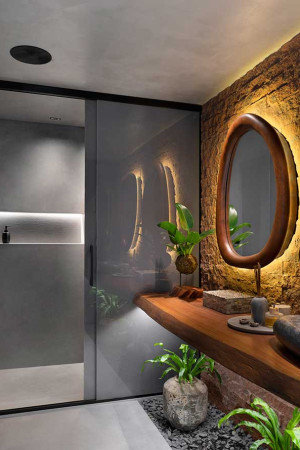 Dentro do lavabo, a caixa acústica no teto e o espelho estilizado unem tecnologia e arquitetura.