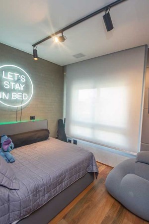 Na suíte do filho adolescente, TV, ar-condicionado e fitas de LED coloridas foram integrados à automação.