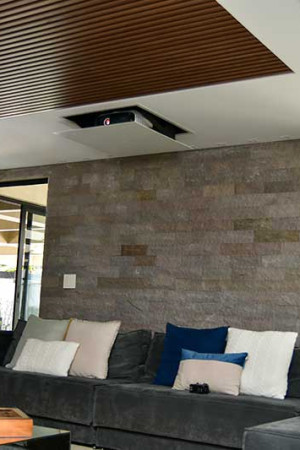 Detalhe do projetor 4K suspenso no lift embutido no forro de gesso